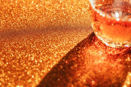 Whisky in a glass on a golden background - 2285562