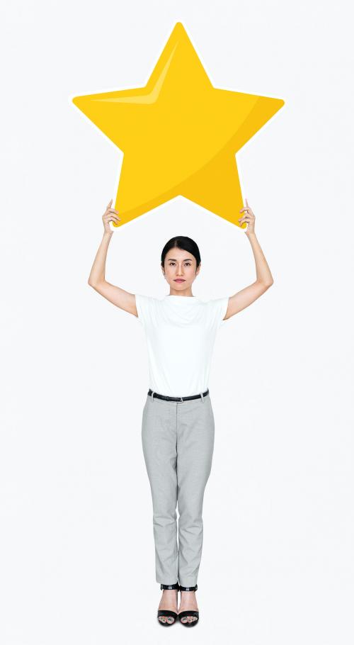 Businesswoman holding a golden star rating symbol - 477830