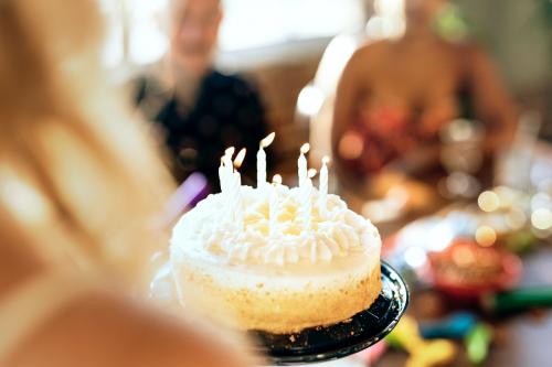 Bringing out the birthday cake at a party - 2097291