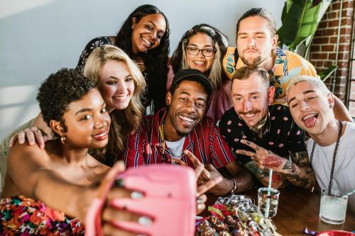 Diverse group of friends taking a selfie at a party - 2097342