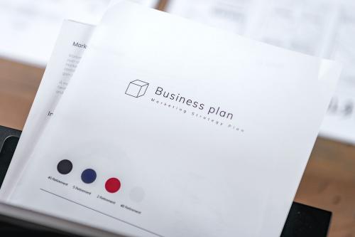 White business plan book on wooden table - 2203478