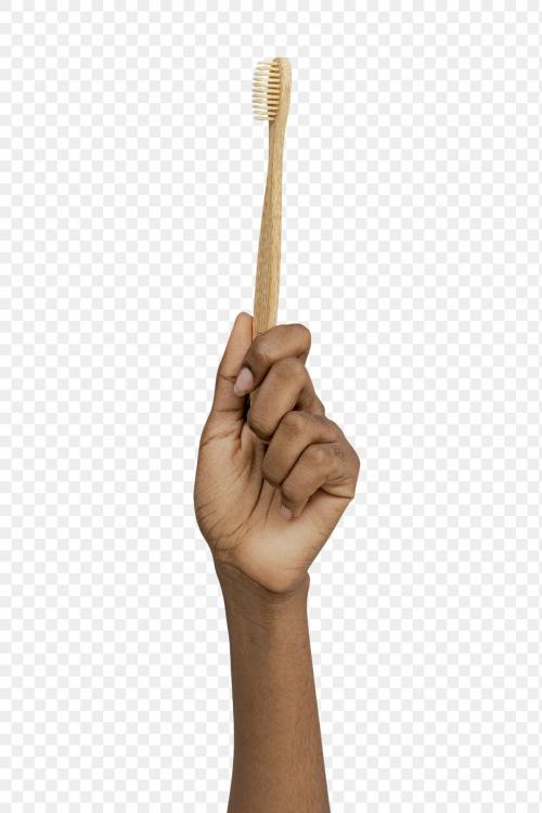Hand showing a bamboo toothbrush transparent png - 2274764