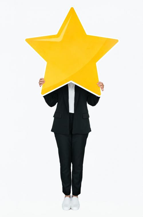 Businesswoman holding a golden star rating symbol - 477433