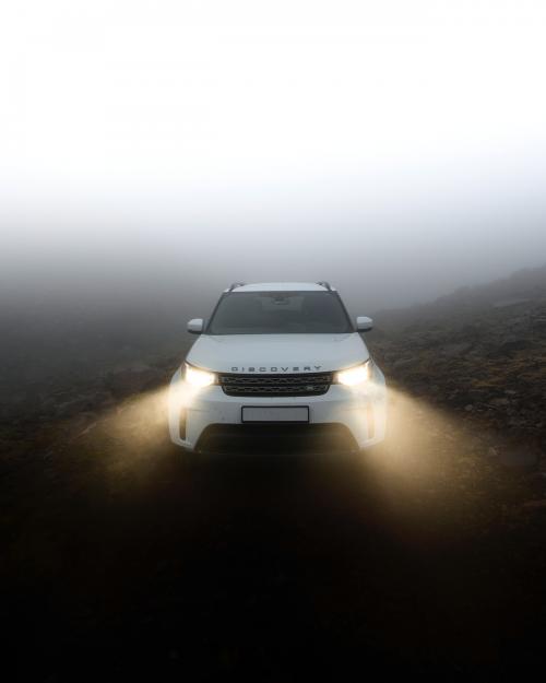 White Land Rover driving in the countryside - 2047639