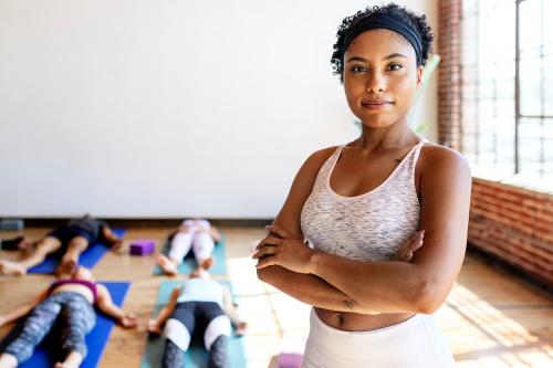 Trainer and her students in a yoga class - 2107395