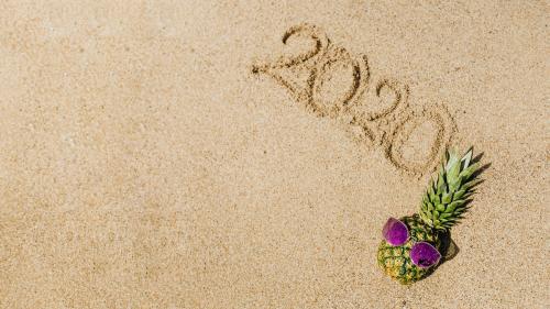 Cool pineapple wearing a purple sunglasses with a year 2020 word on the beach - 1228526