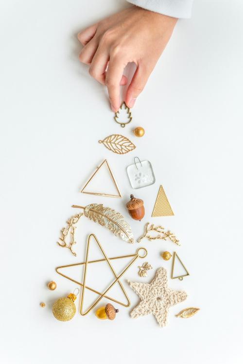 Woman making a Christmas tree with gold ornaments aerial view - 1231714
