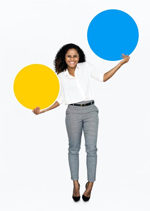 Cheerful woman holding colorful round boards - 475160
