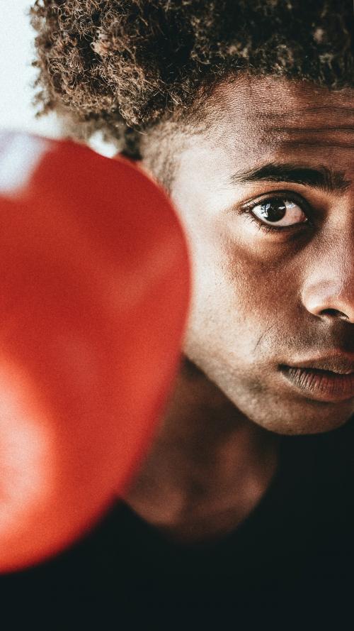 Young fighter wearing boxing gloves mobile phone wallpaper - 1225088
