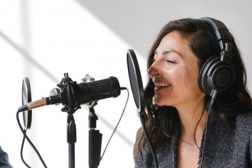 Female singer singing live in a studio - 1225313