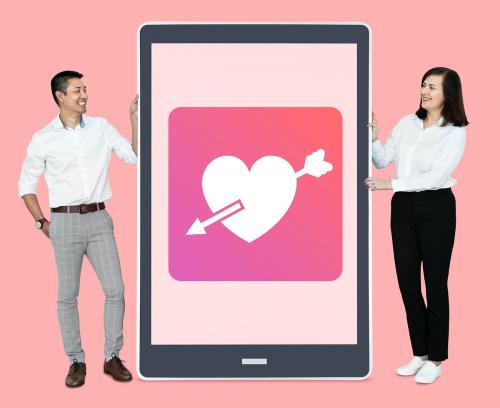 Cheerful couple showing online dating on a tablet - 475388