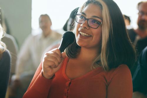 Closeup of a woman speaking on a microphone - 1223783