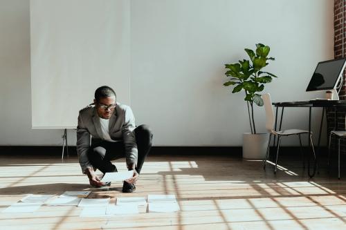 Businessman planning a marketing strategy on a wooden floor - 1226829
