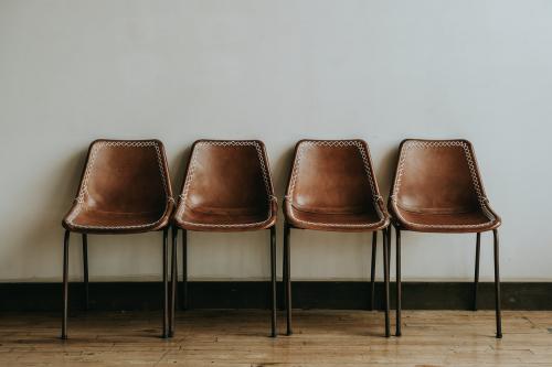 Four empty brown chairs in a room - 1221565
