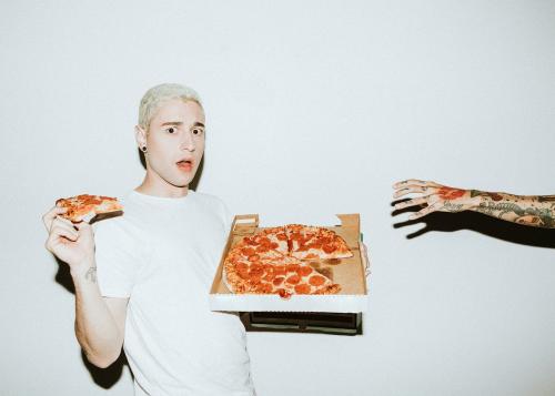 A man having a pepperoni pizza - 1225175