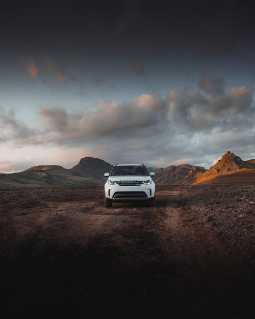 2019, Iceland, White Landrover driving in the countryside - 1227096