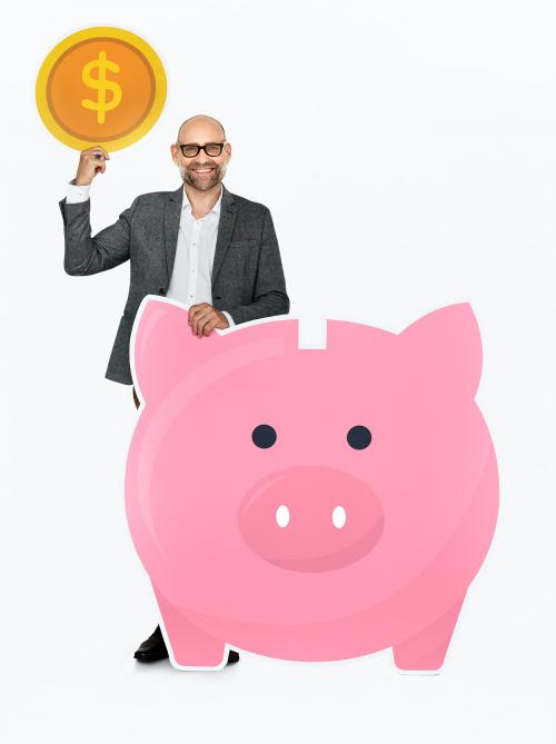 Businessman saving money in a piggy bank - 468259