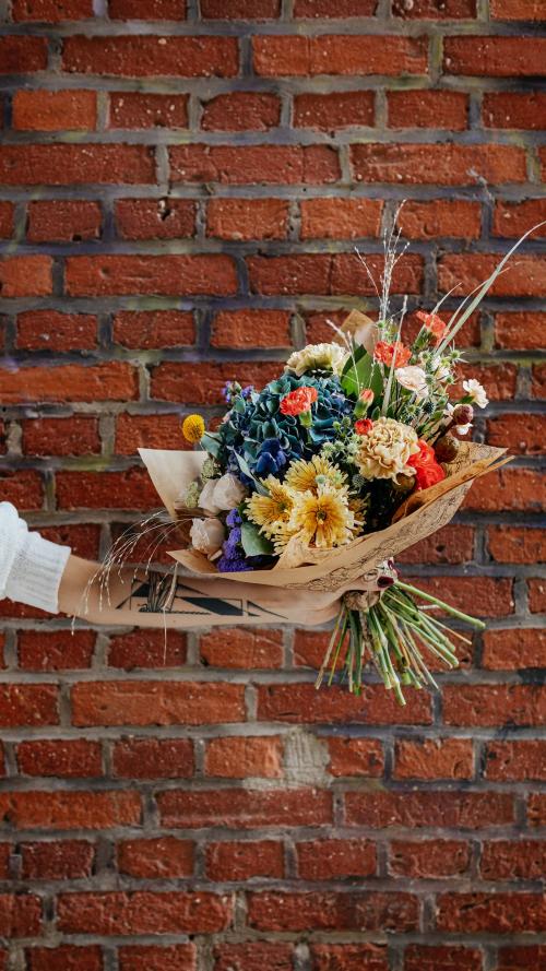 Bouquet of colorful flowers in front of brick wall - 1231958