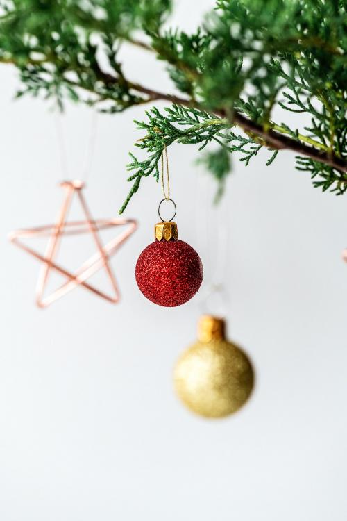 Festive shimmering baubles on a Christmas tree - 1231390