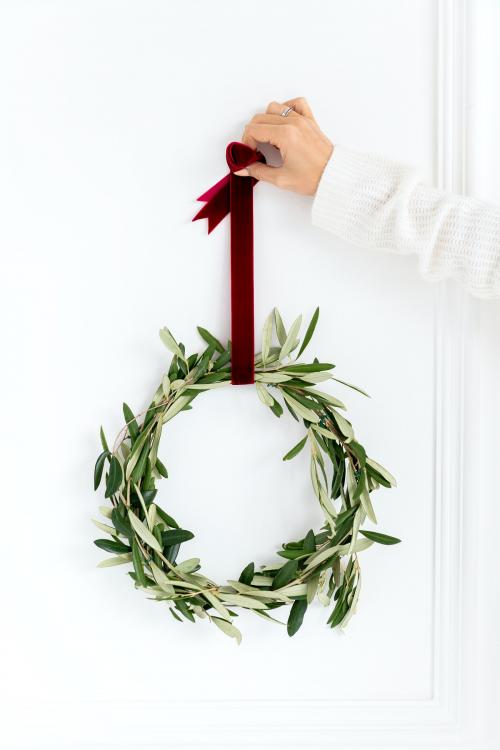 Woman holding a fresh Christmas wreath - 1231817