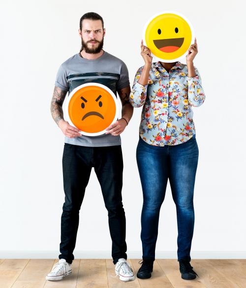 Interracial couple holding an expressive emoticon face facial expression frown and smile relationship issue concept - 414602