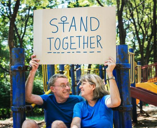Mature couple holding a stand together signboard - 416771