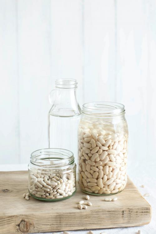 Raw organic white beans in containers - 1225265