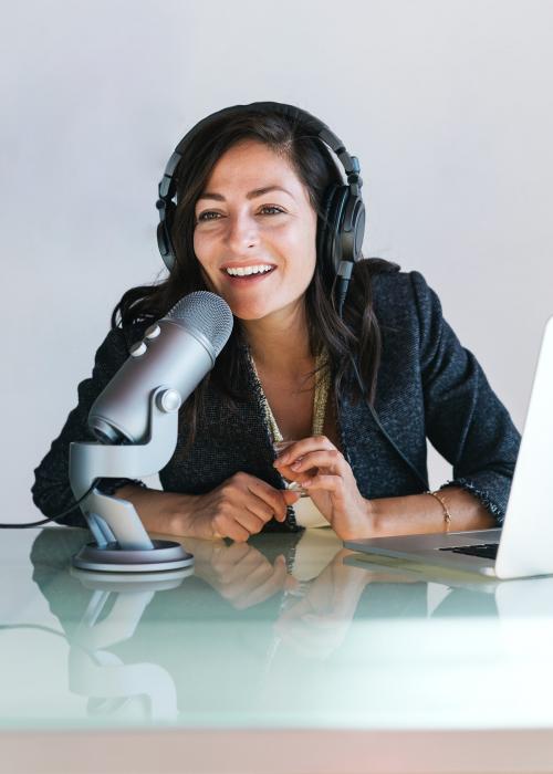 Female radio host broadcasting live in a studio - 1225437