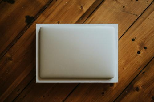 Aerial view of a white laptop on a wooden table - 598316