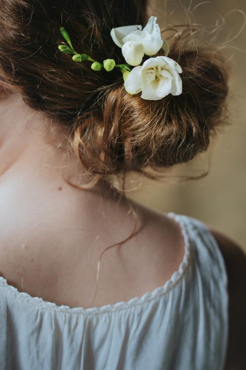Girl with white freesia flowers in her hair - 1207832
