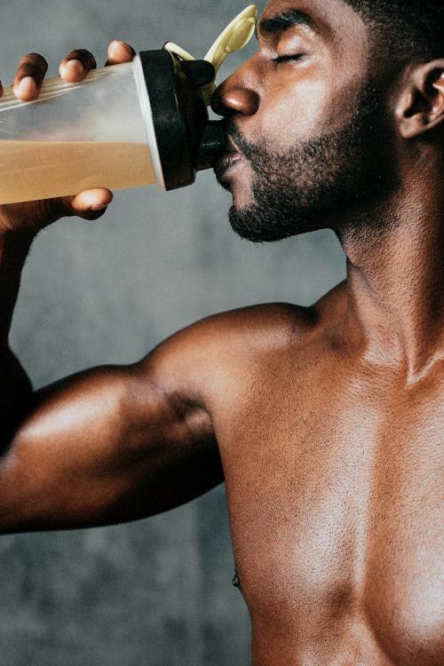 Black man drinking energy drink - 1222504