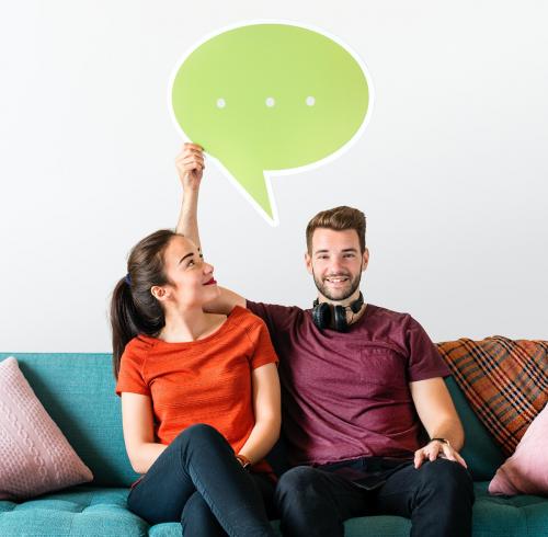 Cheerful people holding speech bubble icon - 414513