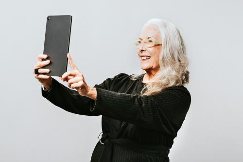 Senior woman taking a photo of herself with a digital tablet - 2019874