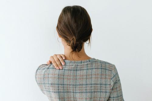 Rearview of a tired woman in a gray plaid dress - 1212567