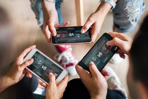 Group of diverse friends playing game on mobile phone - 384510