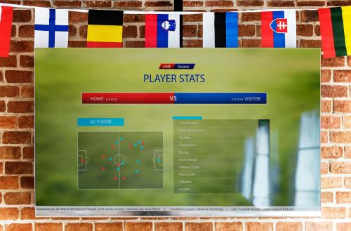 Wide-screen TV displaying player stats of a football match - 384634