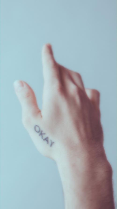 Okay word tattooed on a hand mobile phone wallpaper - 1216468