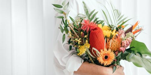 Woman holding a colorful tropical bouquet - 1207417
