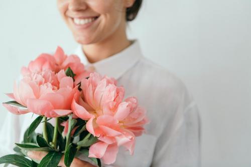Happy woman holding a bouquet of peonies - 1207585