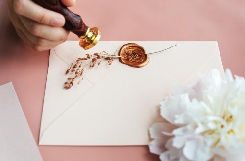 Woman putting a stamp on an envelope mockup - 1212459
