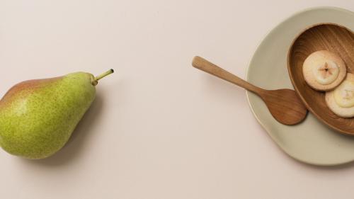 A pear and cookies on the table - 1212572