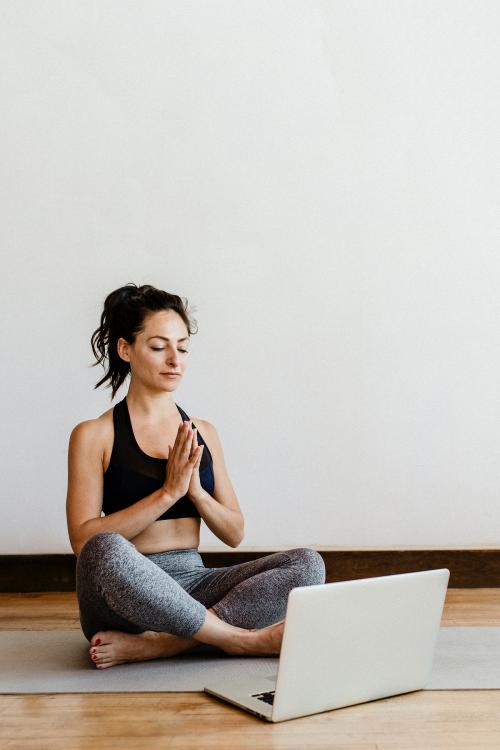 Active woman learning a yoga online via a laptop - 1210046