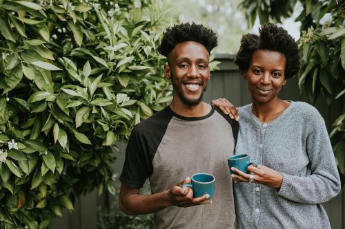 African American couple with coffee in the garden - 1211716
