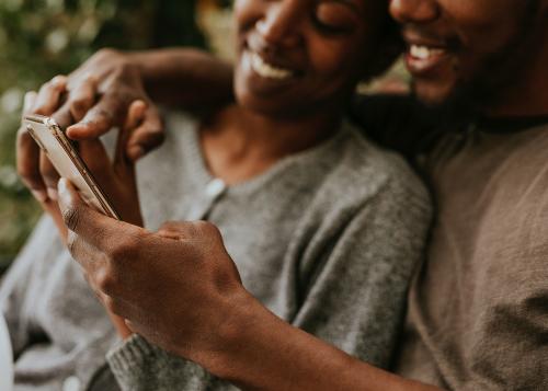 Happy black couple using a smartphone - 1211815
