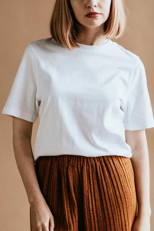 Short brown hair woman in a white tee and a brown skirt - 1216421