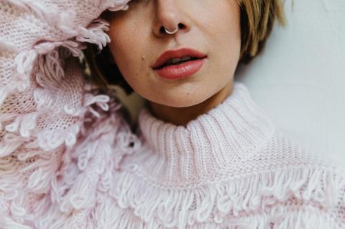 Portrait of a cheerful woman in a light pink sweater - 1200476