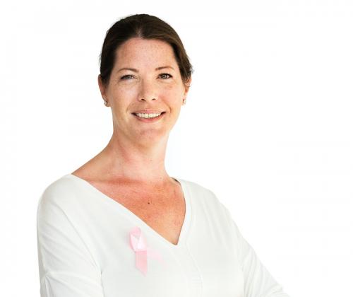 Woman with pink ribbon for breast cancer awareness charity studio portrait - 7574