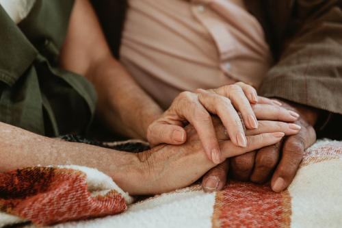 Senior couple holding hands together - 1202578
