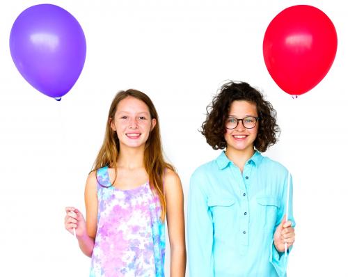 Two girl is holding a color balloon - 7588