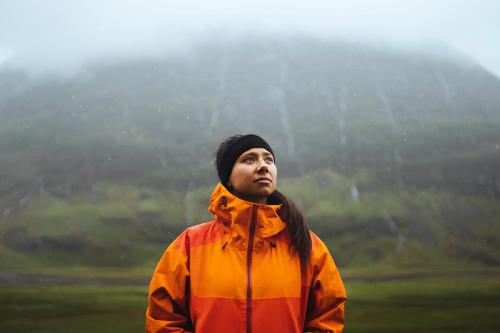 Woman in waterproof jacket while trekking in the highlands - 1077885